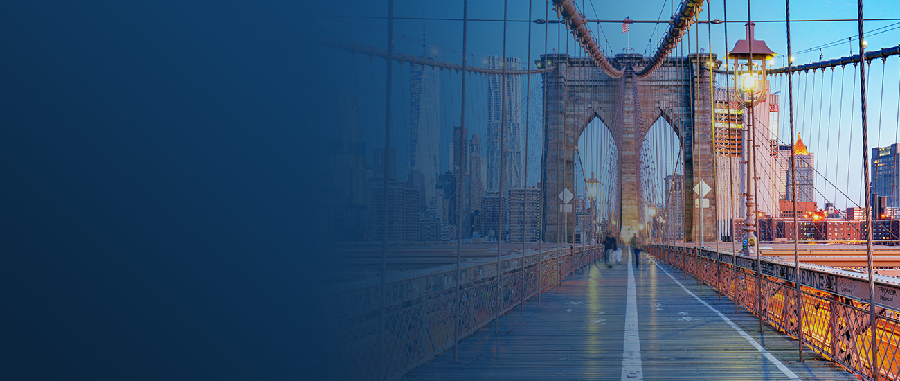 Brooklyn Bridge pedestrian walkway at dusk.